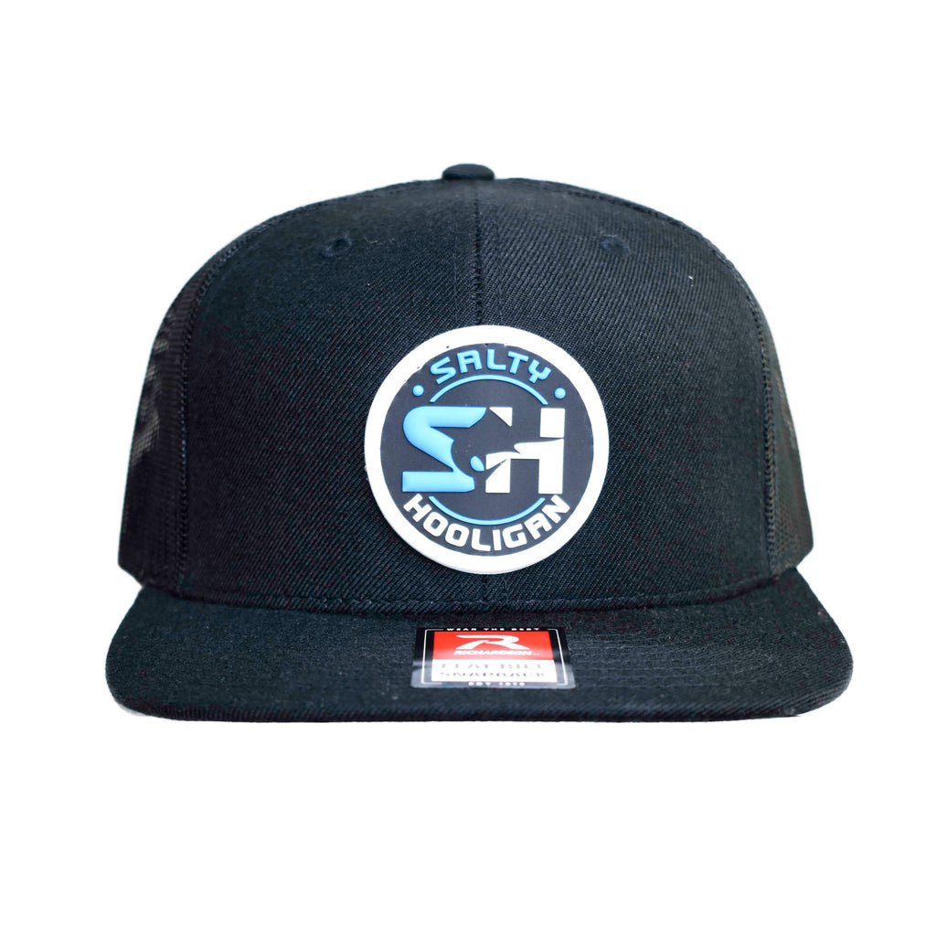 Flat bill trucker cap in navy with round Salty Hooligan patch, front view